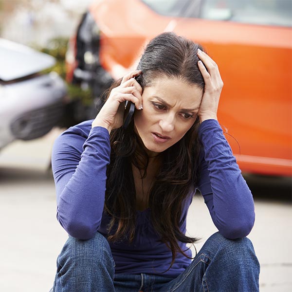 Female Driver Making Phone Call After Traffic Accident