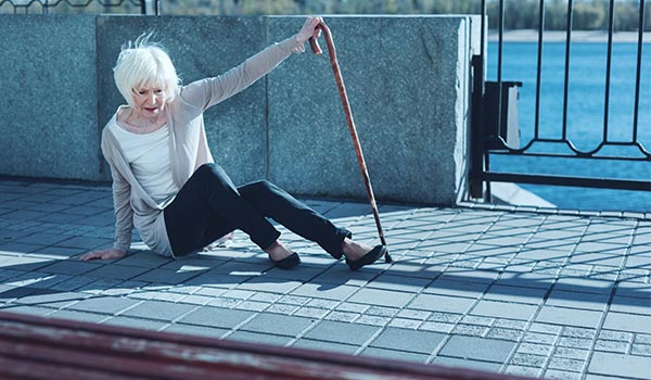 Senior Woman Slipping on Poorly Maintained Sidewalk